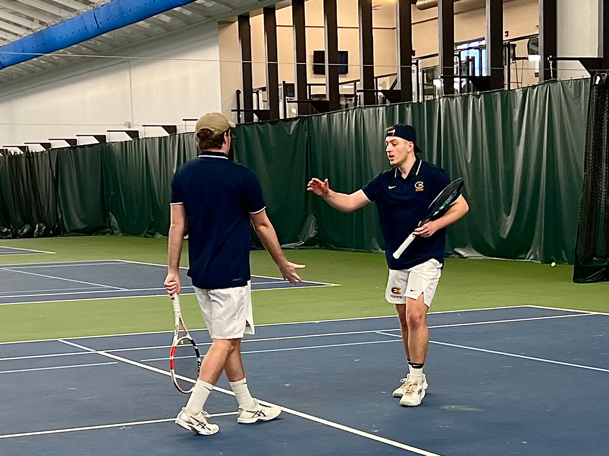 Demetri Bush and Ethan Wurtzel celebrate after winning match point at two doubles.