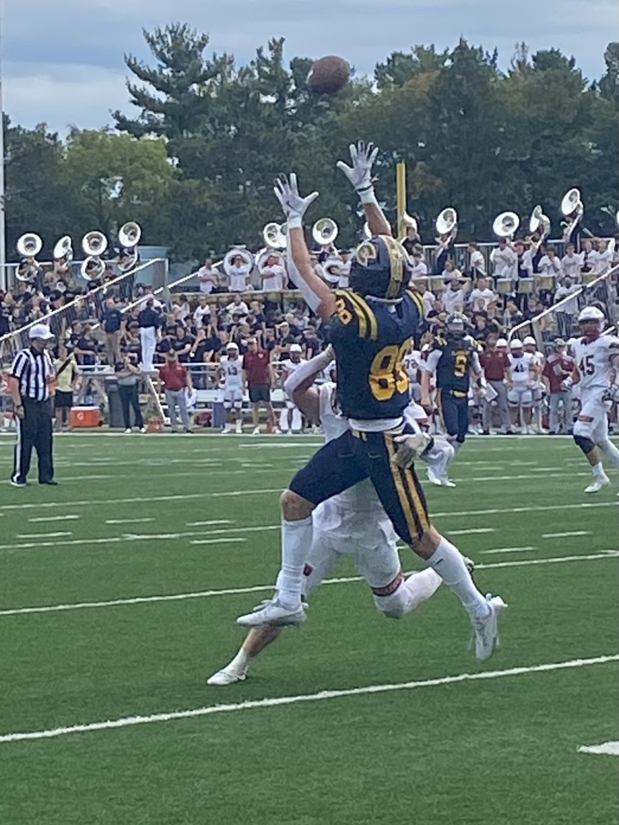 Nolan Stans catches a touchdown over a Coe defender.