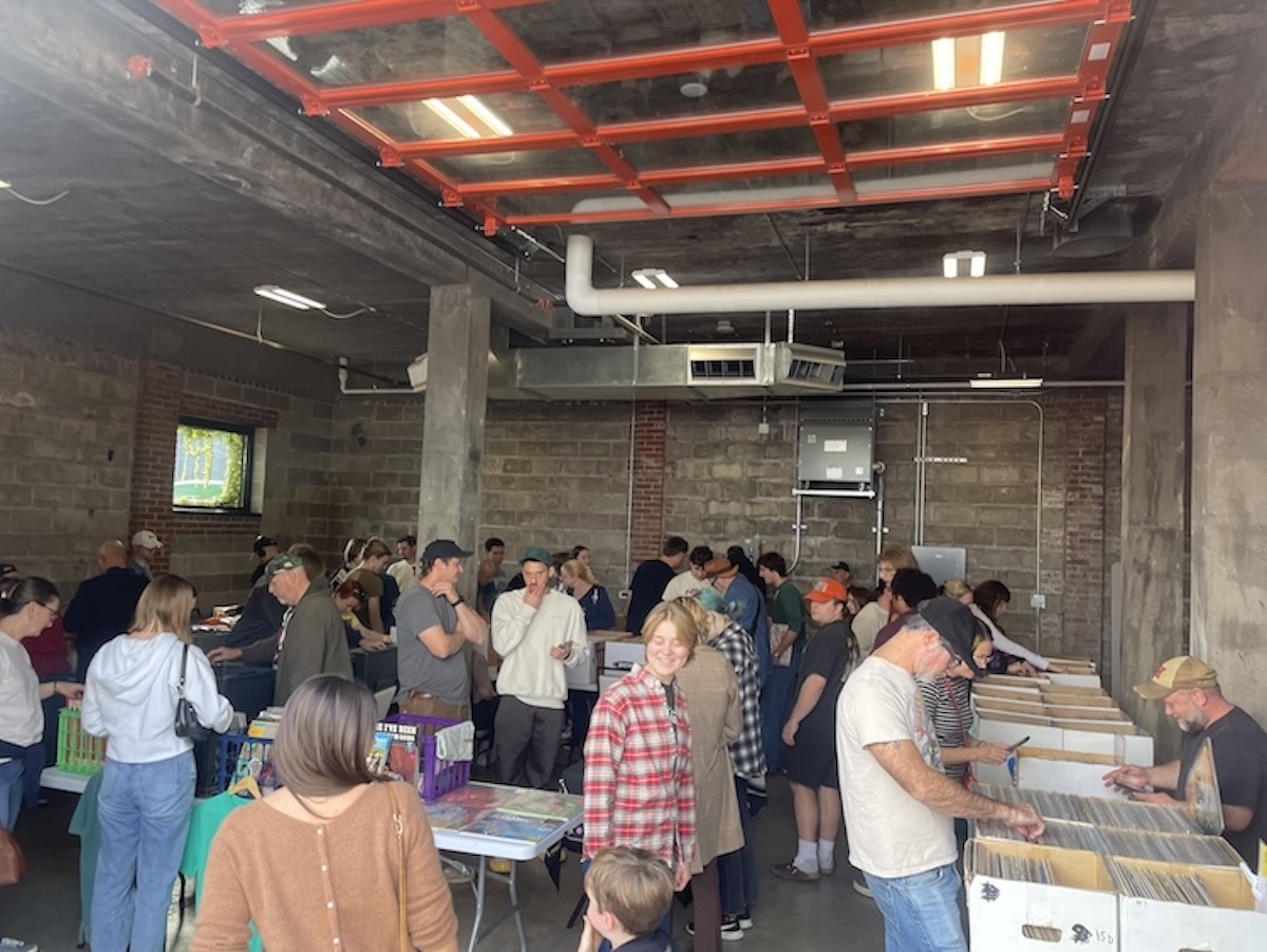 Patrons browse the vinyl selection on display in The Garage portion of The Brewing Projekt.