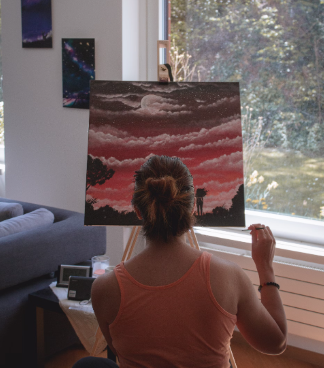  A woman is painting clouds on a canvas. Susanna Marsiglia. Taken from Unsplash
