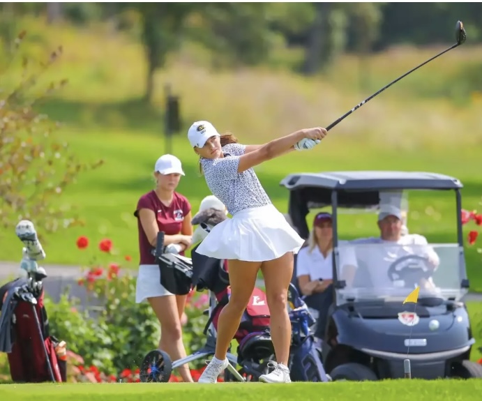 Second-year Lilly Kaminski lines up for a tee shot.