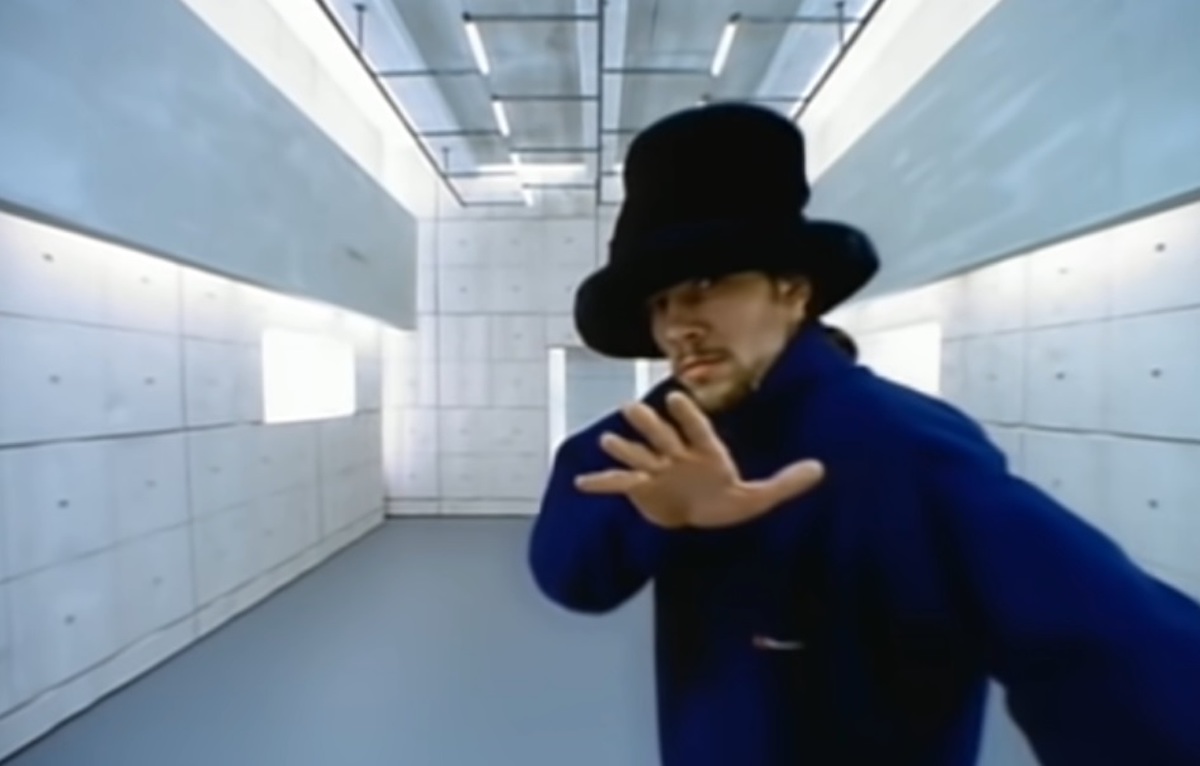 Jay Kay dancing, walking and rearranging furniture in the classic music video. (Photo from Sony)