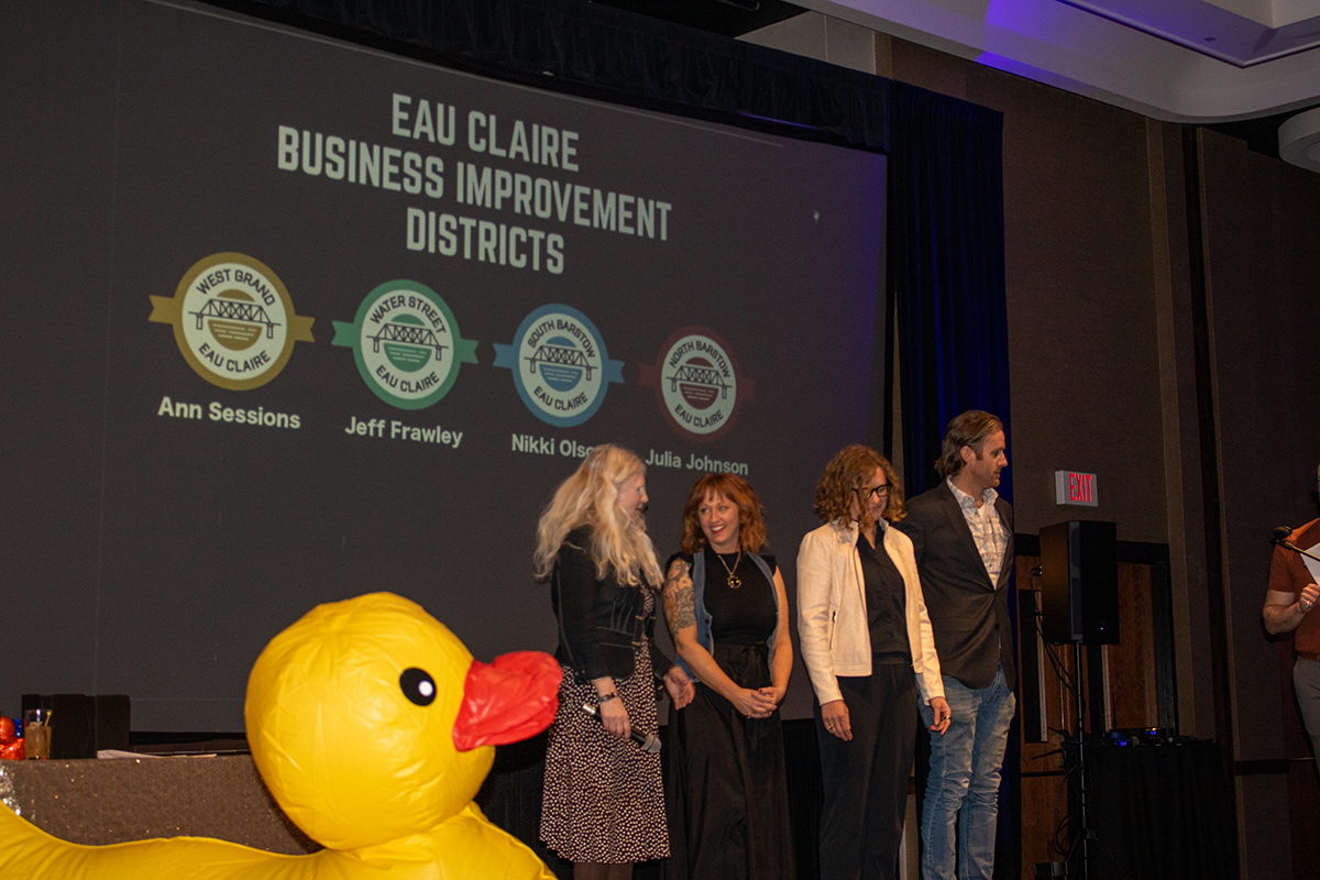 Eau Claire business improvement district directors discussing their districts to the audience members. Ann Sessions represents the West Grand district, Nikki Olson represents South Barstow, Julia Johnson represents North Barstow and Jeff Frawley represents Water Street.